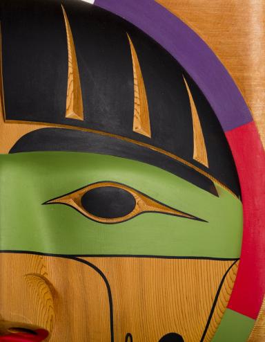 Carved wooden faces Partially obscured.