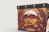 A carved wooden box with the image of an agonized face.