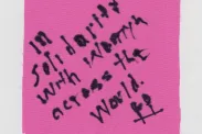 Piece of cloth with "In solidarity with women across the world." written.
