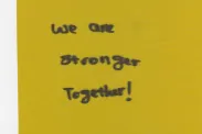 Piece of cloth with "We are stronger together!" written.