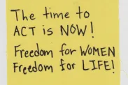 Piece of cloth with "The time to act is NOW! Freedom for WOMEN Freedom for LIFE!" written.