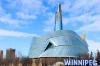 Image of the CMHR in the winter with Winnipeg sign.