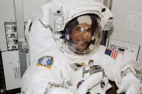 A smiling man in an astronaut suit.