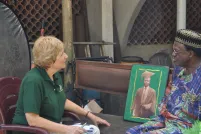 Two people in conversation seated across from each other.