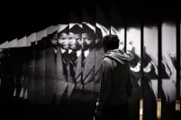 A person walks in front of a large photograph of Nelson Mandela.