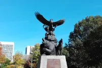 The National Aboriginal Veterans monument, an outdoor statue featuring three Indigenous veterans, a bear, a wolf and an eagle taking flight on top.