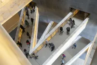Students walking on ramps that connect various levels of museum galleries.