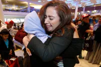 A woman hugs her aunt upon arriving at the Winnipeg airport.