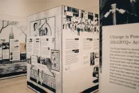 A pop-up exhibition showing three separate black and white cube-shaped panels. The closest one displays "Change is possible."