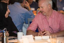 Two people talking at a table.