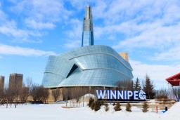 Image of the CMHR in the winter with Winnipeg sign.
