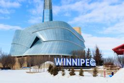 Image of the CMHR in the winter with Winnipeg sign.