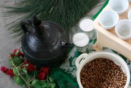 Close-up of someone pouring coffee from a Jebena, a traditional Ethiopian coffee pot.