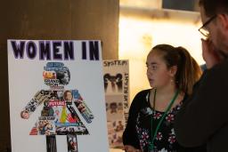 Two people looking at a poster.