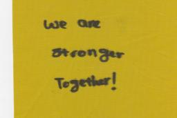 Piece of cloth with "We are stronger together!" written.