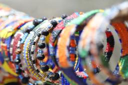 A display of colourful beaded bracelets are displayed for sale.