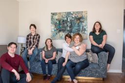 A smiling family of six in a living room.