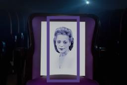 A head-and-shoulder portrait of Viola Desmond framed by a vertical purple rectangle. Viola is wearing a white top.