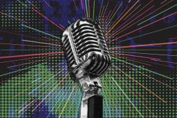 An antique chrome-plated microphone in the centre of the image is encircled by multicoloured rays over a mottled blue and green background.