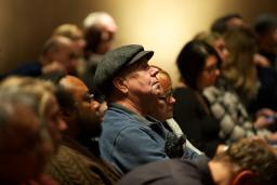 People sitting in an audience.