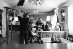 Filming a scene of the movie Fruit Machine, 2 people conversing at a kitchen counter.