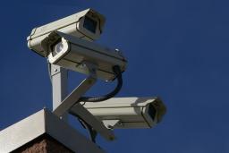 Three surveillance cameras on the corner of a building