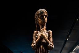 A statue of a girl holding stalks of wheat.