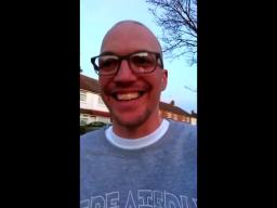 A self-shot photo of a man wearing glasses looking into the camera.
