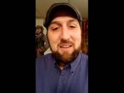 A self-shot photo of a bearded man wearing a cap.