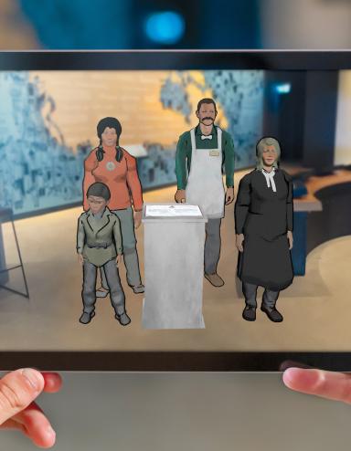 A visitor's hands hold a tablet that carries an image of four animated people including a little boy, a young Indigenous woman, a man wearing an apron and a woman judge. Partially obscured.