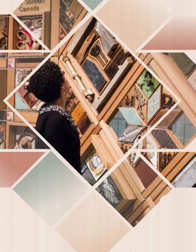 A person with curly hair, glasses and wearing a black top examines a large artwork consisting of objects set in cedar frames. The image has been broken into interlocking geometric shapes over a pale brown background with a slight wood grain texture. Partially obscured.
