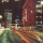 Late 1960s-era photo of downtown Winnipeg showing the Eaton’s building decorated with many bright Christmas lights.