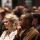 A crowd of people sitting and listening intently.
