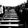 People stand in front of a row of coffins.