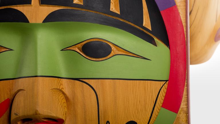 Carved wooden faces Partially obscured.