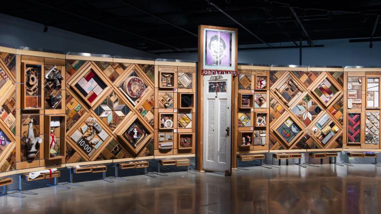 Large artwork consisting of objects set in cedar frames. Partially obscured.