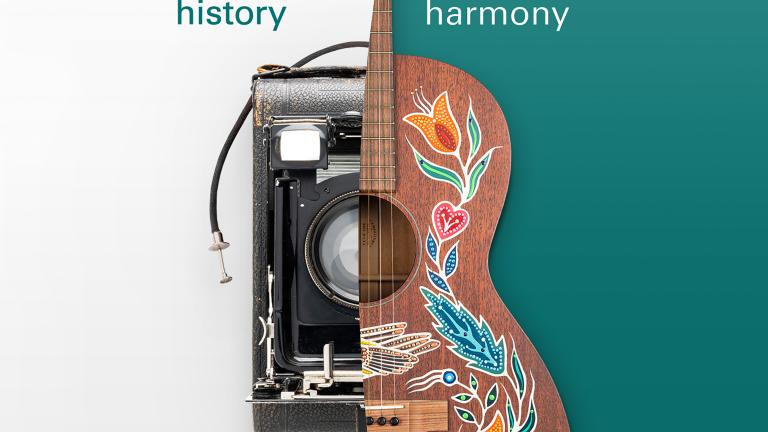 A 1940s-era camera and an acoustic guitar decorated with painted patterns. Partially obscured.
