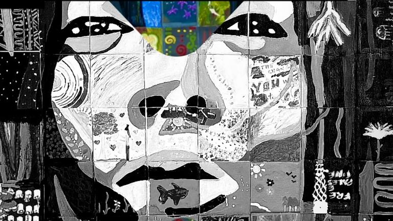 A painting, mostly in black and white with a few splashes of colour, is in the style of a mosaic so that different tiles contain various natural elements—a fish, flowers, mountains, fields. Together the tiles become a human face directly looking at the viewer with an intense expression. Partially obscured.