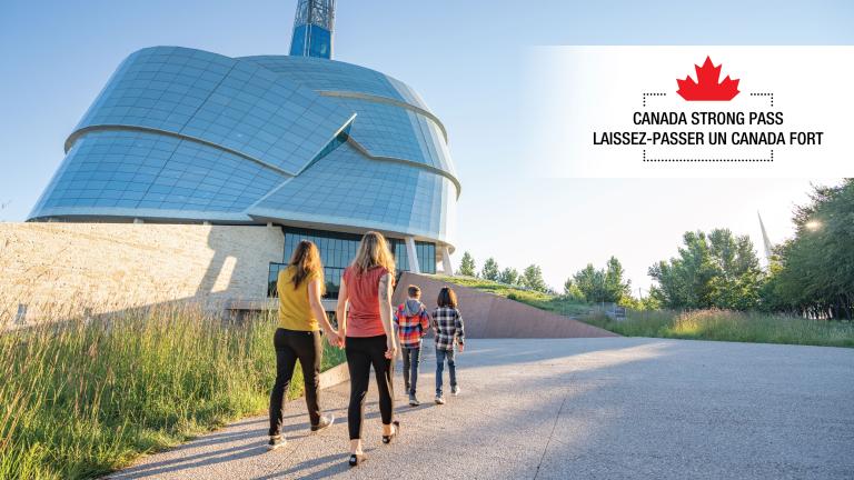 A group of people walk towards a glass building surrounded by greenery. At the top of the image, we can read "Canada Strong Pass" in English and French. Partially obscured.