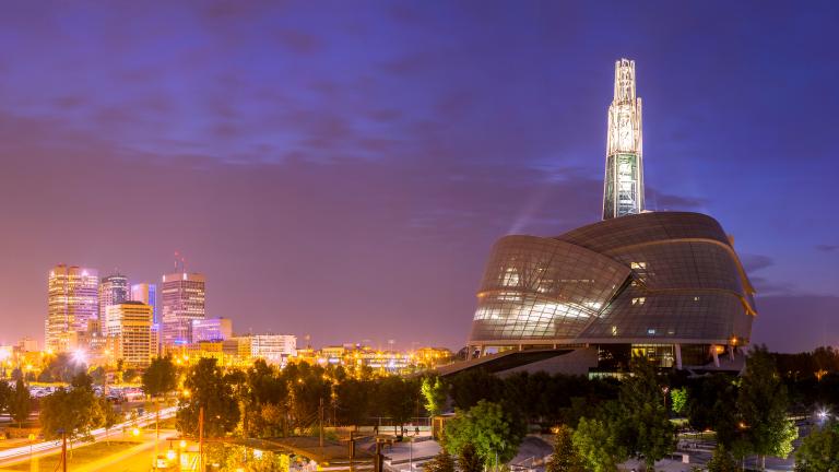 A panoramic shot of the Museum and the Winnipeg skyline at dusk.