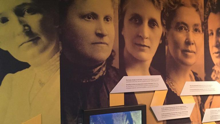 Large photographs of five women on the wall of a Museum exhibit. They are the "Famous Five" - Nellie McLung, Emily Murphy, Irene Parlby, Louise McKinney and Henrietta Edwards. Partially obscured.