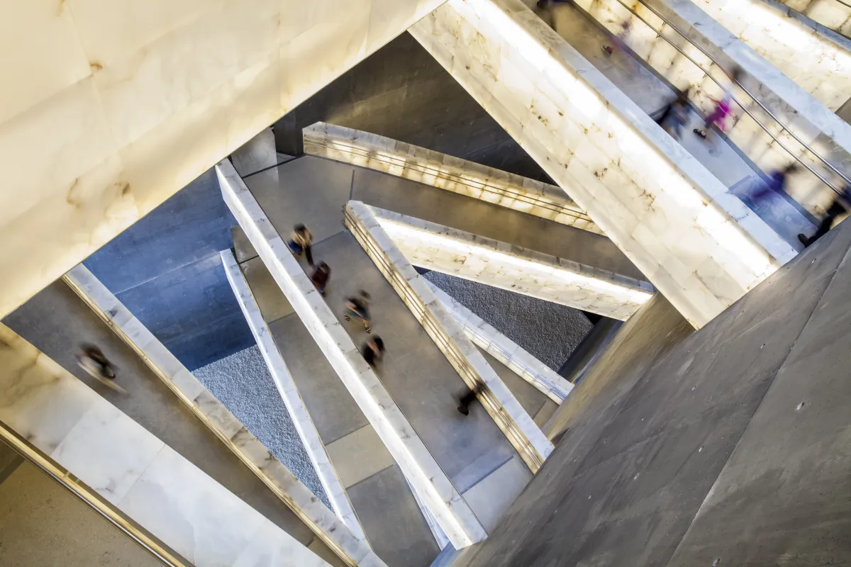 Looking down through the Museum’s cross-crossing alabaster ramps as people move through them.