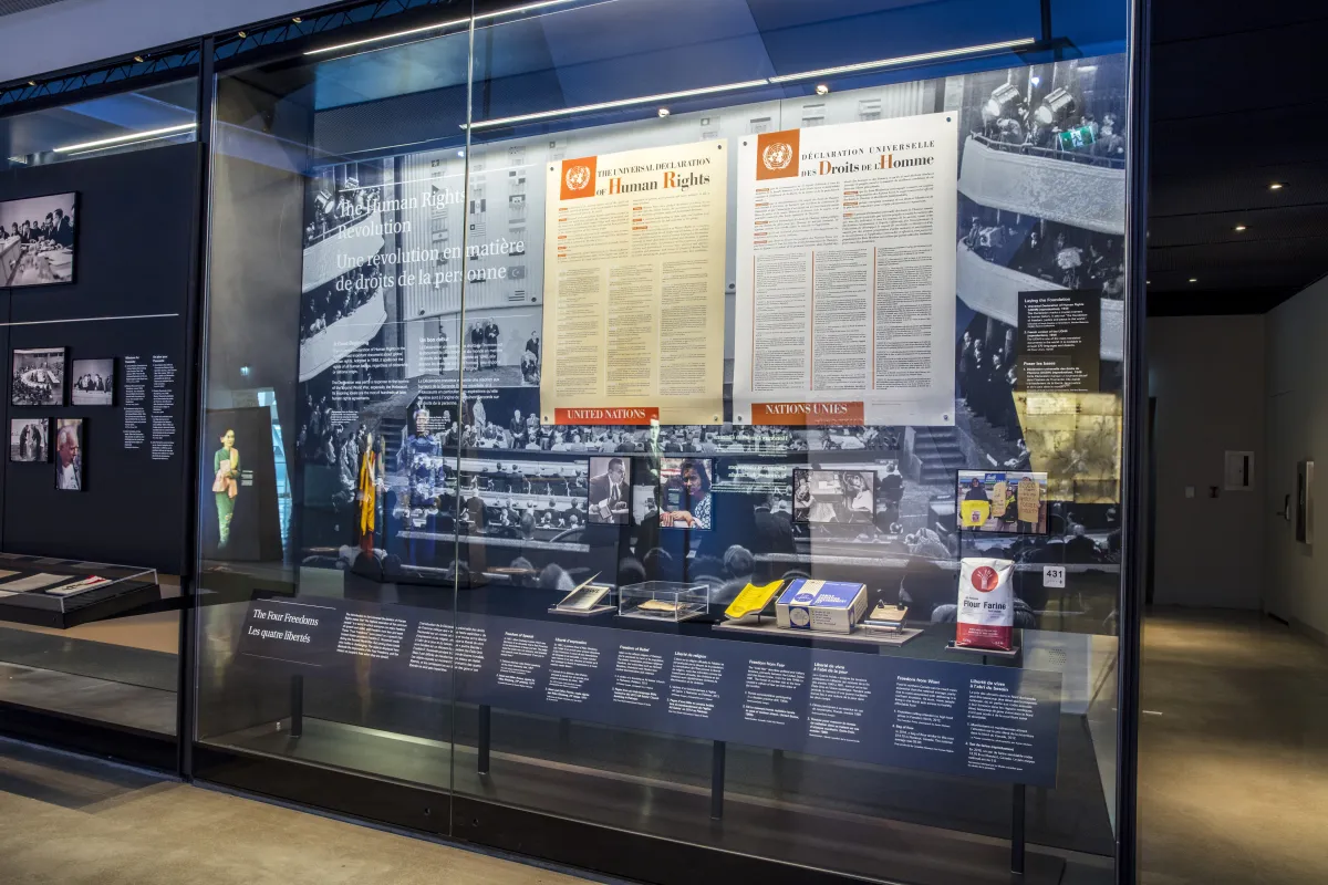 A large glass case contains objects.