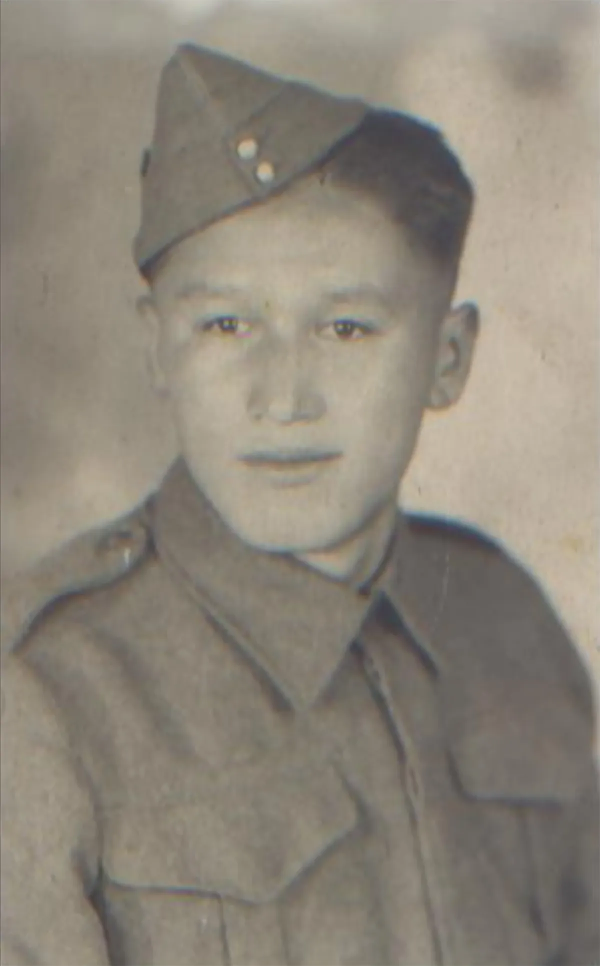 A young man wearing a military uniform.