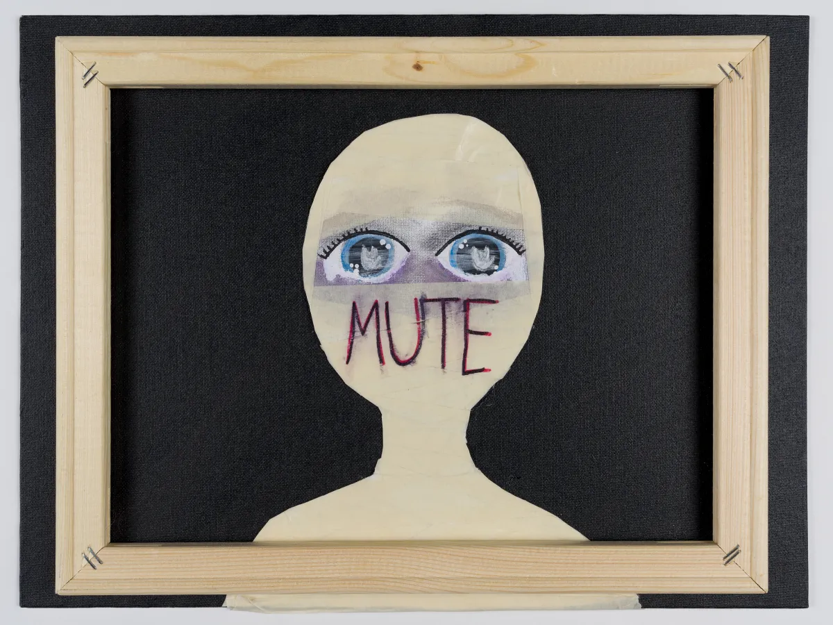 A cut-out shape of a girl’s head is wrapped in masking tape that covers her mouth and nose, with only large, sad-looking eyes revealed. Inside each pupil is the ASL sign for love.
