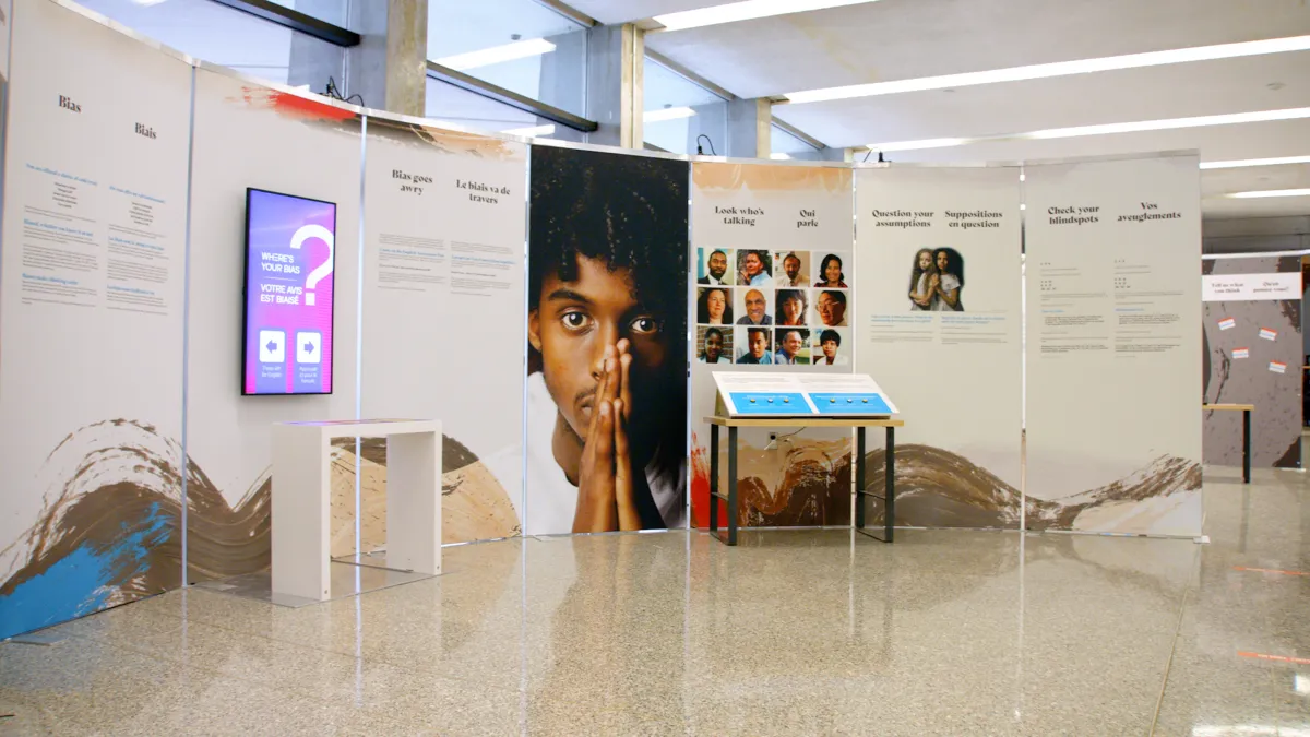 A freestanding set of panels presenting text, video and interactive digital displays.