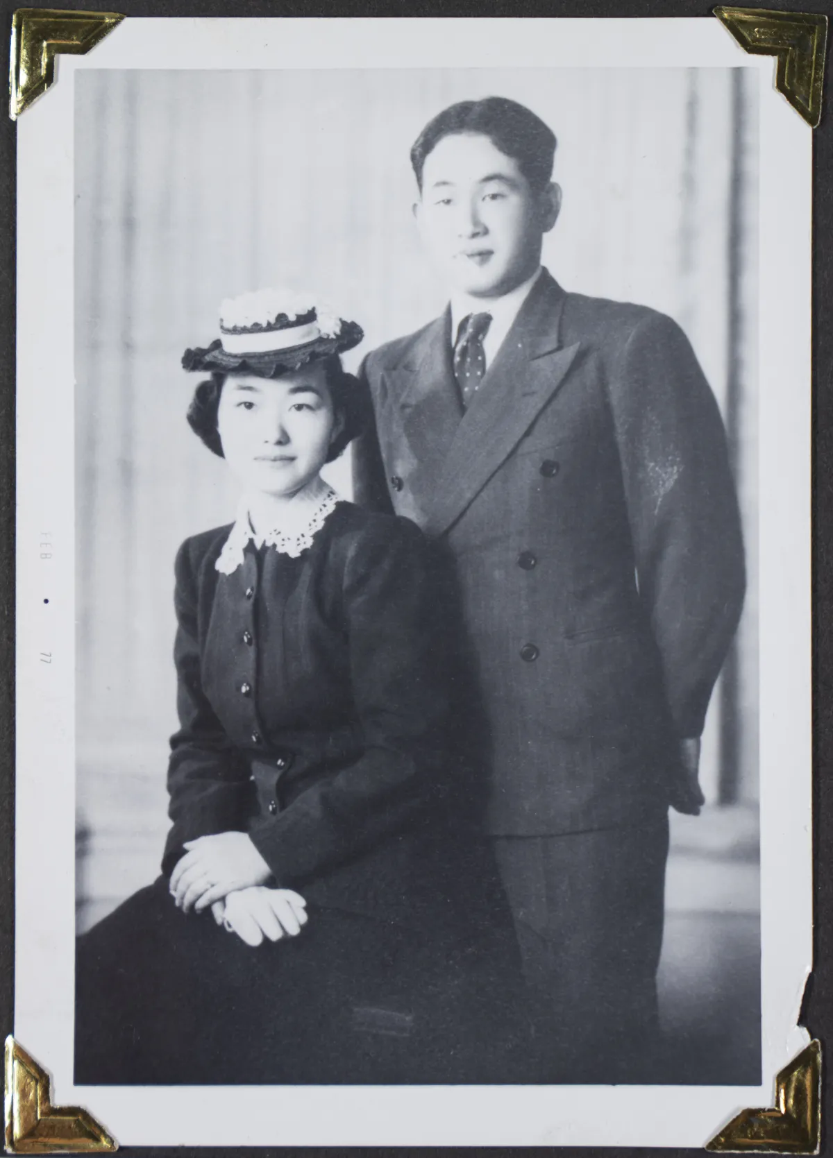 A young woman and a young man pose in formal wear.