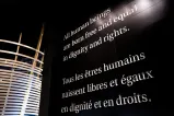 Large white text on a black wall reading "All human beings are born free and equal in dignity and rights."