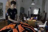 A teenage boy installs lifejackets onto a dome-like structure.