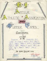 A handwritten certificate with stylized writing. It is written in chiefly black ink, but some letters are coloured in blue or yellow. The top of the certificate reads “R.I. Amateur Athletic Association 1972 Summer Games.”